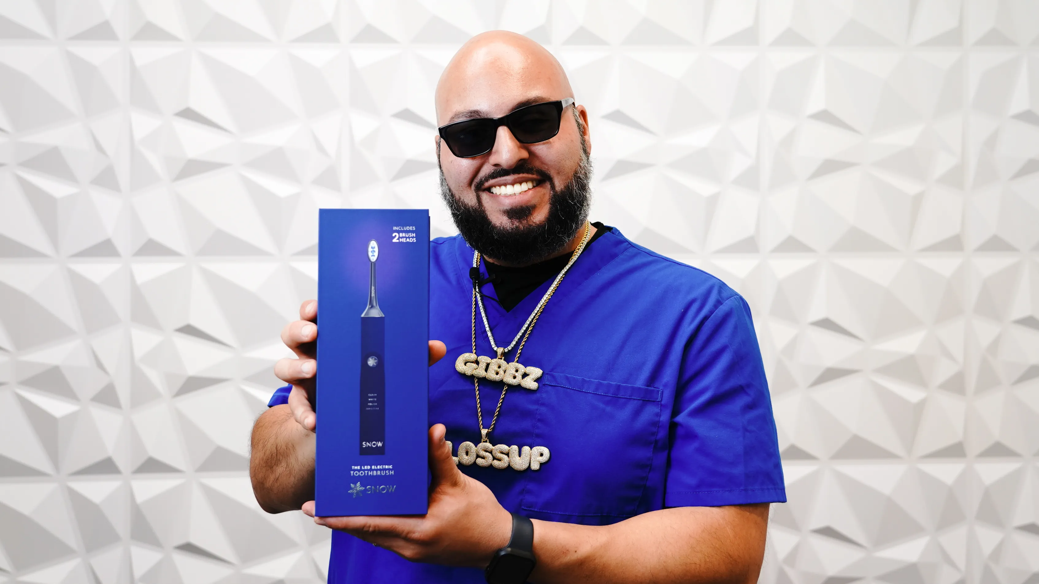 Creator holding an electric toothbrush