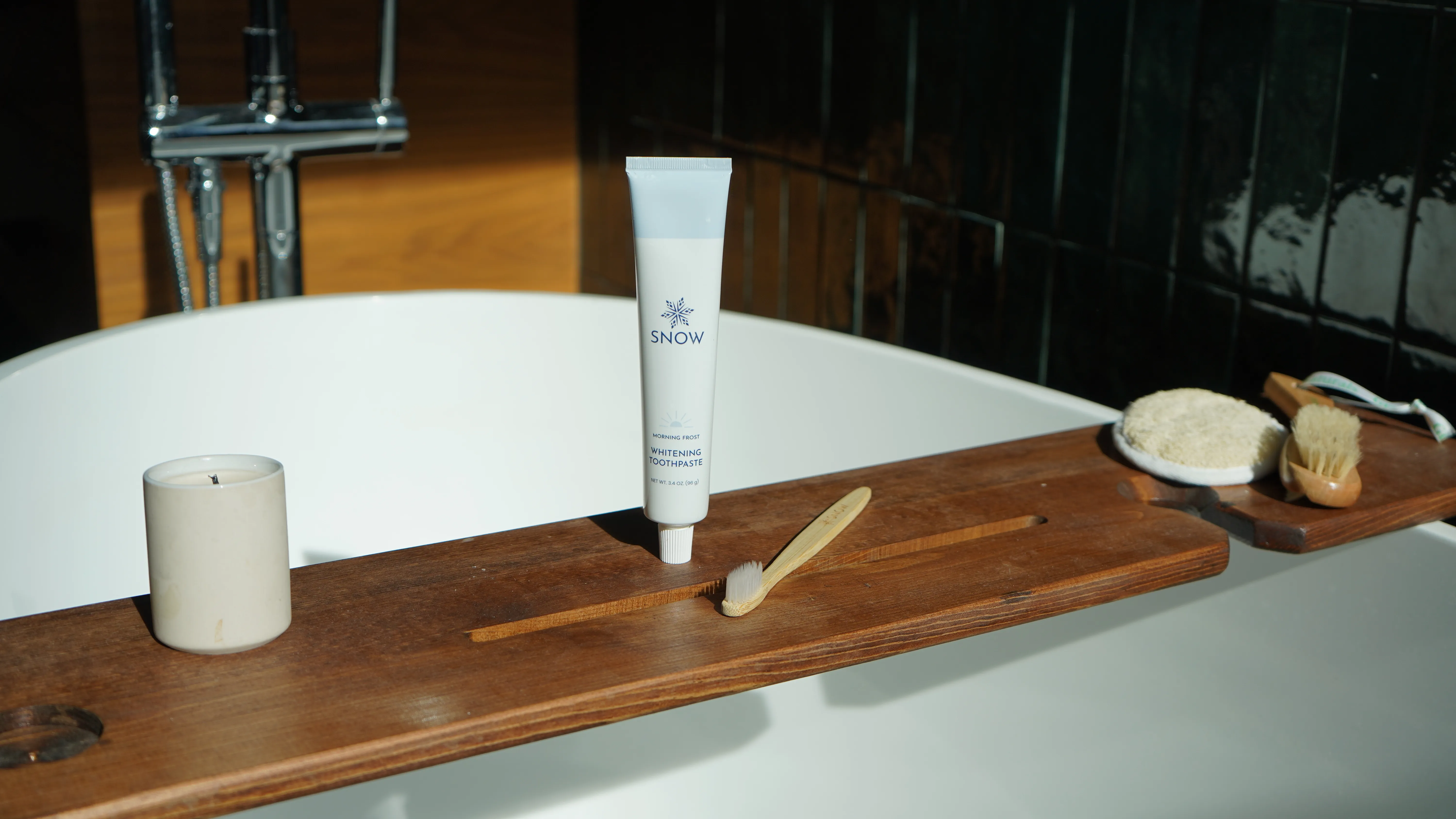 Skincare tube styled on a bath tray
