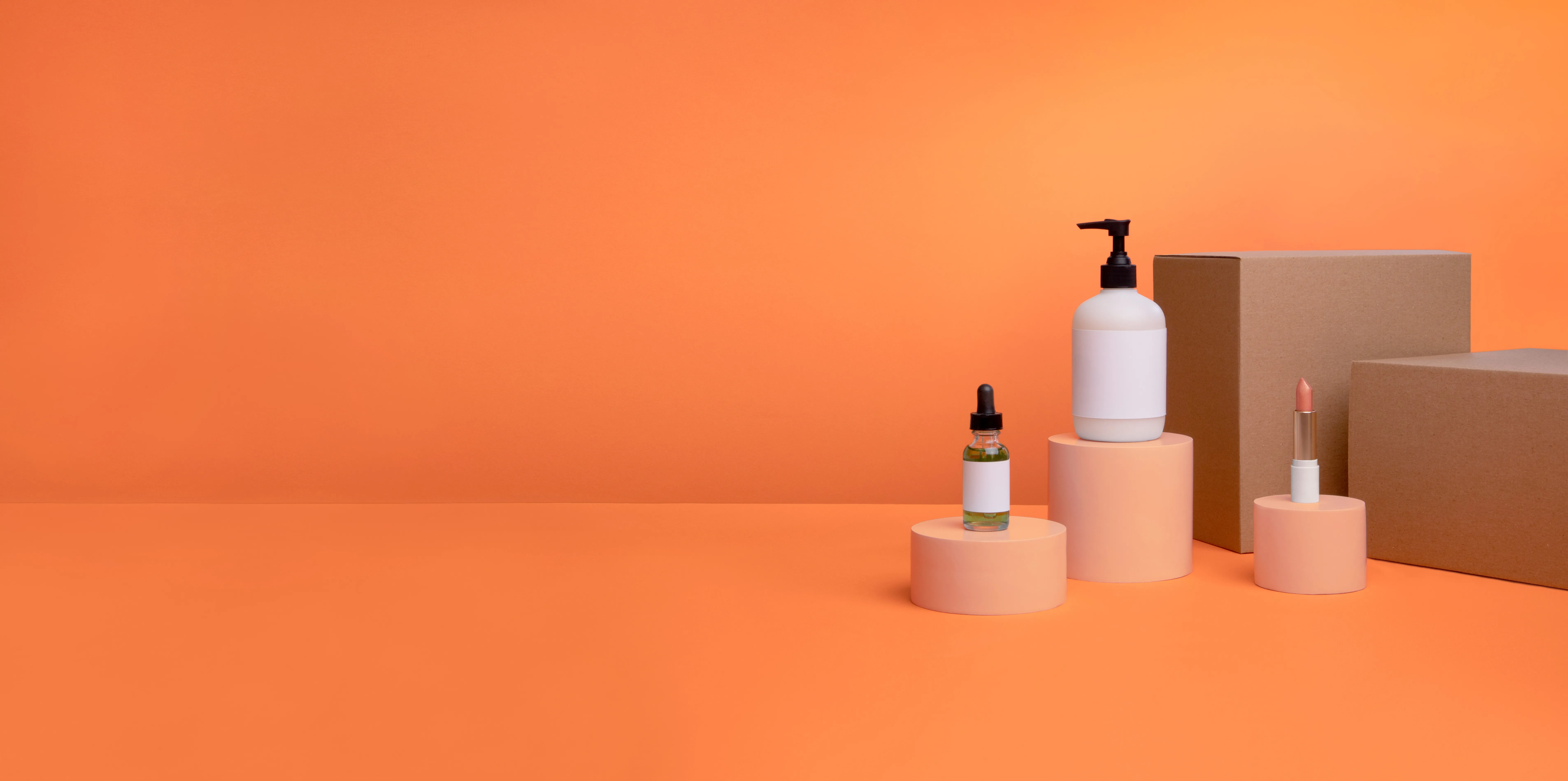 Skincare products on peach pedestals